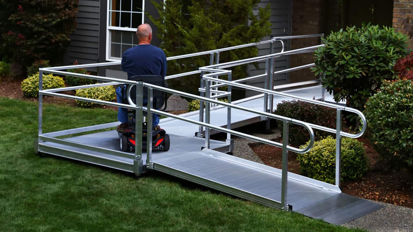 man on wheelchair using semi permanent ramp