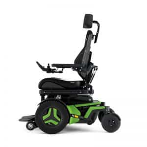 Power wheelchair facing left with two green wheels on each side